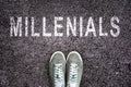 Text Millennials written on asphalt with shoes