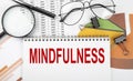Text MINDFULNESS on white paper notebook on the diagram. Business concept