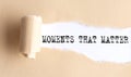 The text MOMENTS THAT MATTER appears on torn paper on white background Royalty Free Stock Photo