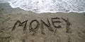 text MONEY on the sand of the sea