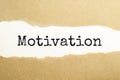 The text motivation appearing behind torn brown paper Royalty Free Stock Photo