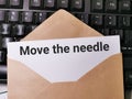 Text MOVE THE NEEDLE written on white paper note in the envelope on computer keyboard. Royalty Free Stock Photo