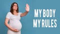 Text my body my rules and pregnant woman raised her hands in the air