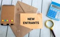 text NEW ENTRANTS on white short note paper on yellow background Royalty Free Stock Photo