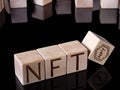 Text NFT on wooden blocks as concept of non-fungible tokens trading