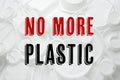 Text NO MORE PLASTIC and different disposable items on background, top view