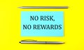 Text NO RISK NO REWARDS on the blue sticker on the yellow background