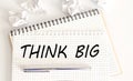 Text on notepad THINK BIG on white background. Business Concept Royalty Free Stock Photo