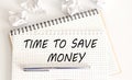 Text on notepad TIME TO SAVE MONEY on the white background. Business Concept Royalty Free Stock Photo