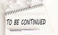 Text on notepad to be continued on white background. Business Concept Royalty Free Stock Photo