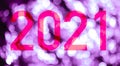 Text with the number of the year 2021 with a background of bright lights out of focus in pink tones. Royalty Free Stock Photo