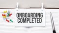 text onboarding completed on stickers on the diary with office tools Royalty Free Stock Photo