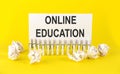 Text ONLINE EDUCATION on the white short note paper yellow background Royalty Free Stock Photo