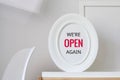 Text we are open again. white oval frame with minimal background. modern interior. contemporary furniture Royalty Free Stock Photo