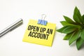 Text OPEN UP AN ACCOUNT on white paper on clipboard with chart and calculator Royalty Free Stock Photo
