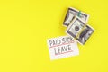 Text paid sick leave and money on a yellow background