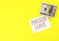 Text paid sick leave and money on a yellow background