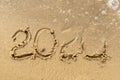 2020 text painted on the sand. Water washed away the text on the beach. The 2021 year is coming Royalty Free Stock Photo