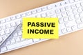 Text PASSIVE INCOME text on a sticky on keyboard, business concept