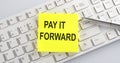 Text PAY IT FORWARD on the keyboard on the white background Royalty Free Stock Photo
