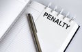 Text PENALTY on the short note texture background with pen. Business concept Royalty Free Stock Photo