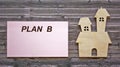 The text of plan B is written on a sticker, an icon of the house lies
