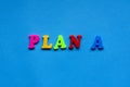 text plan a from plastic colored letters on blue paper background. Royalty Free Stock Photo
