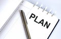 Text PLAN on the short note texture background with pen Royalty Free Stock Photo