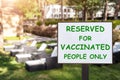 Text plate RESERVED FOR VACCINATED PEOPLE ONLY at luxury hotel pool beach resort area empty loungers on summer day. New Royalty Free Stock Photo