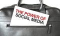 Text THE POWER OF SOCIAL MEDIA writing on white paper sheet in the black business bag. Business concept Royalty Free Stock Photo
