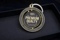 Text of hundred percent premium quality guaranteed on badge and keychain