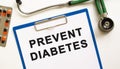 Text PREVENT DIABETES in the folder with the stethoscope. Medical concept