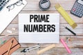 Text Prime Numbers in light box on office desk flat lay Royalty Free Stock Photo