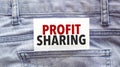Text profit sharing on a white paper stuck out from jeans pocket. Business concept