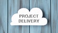 Text PROJECT DELIVERY on white paper in the form of a cloud on a beautiful Royalty Free Stock Photo