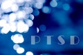 text ptsd on a blue bokeh abstract light background Royalty Free Stock Photo