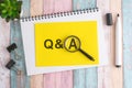 text Q and A under a magnifying glass on a yellow background, top view, the text is written in black marker Royalty Free Stock Photo