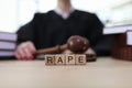 Text Rape on cubes on wooden judge counter in courtroom Royalty Free Stock Photo