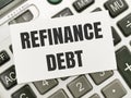 Text REFINANCE DEBT written on white paper note on calculator. Royalty Free Stock Photo