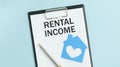 Text RENTAL INCOME on the short note texture Royalty Free Stock Photo