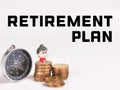 Text Retirement plan with stacked coins,miniature old woman and magnetic compass isolated on white background. Royalty Free Stock Photo