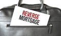 Text reverse mortgage writing on white paper sheet in the black business bag. Business concept Royalty Free Stock Photo