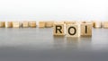 text ROI on wooden cubes on gray background. abbreviation of 'Return On Investment'. square wood blocks. top Royalty Free Stock Photo