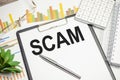 Text scam on paper on the keyboard with office tools Royalty Free Stock Photo
