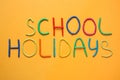 Text School Holidays made of modelling clay on background, flat lay Royalty Free Stock Photo