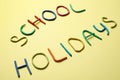 Text School Holidays made of modelling clay on background Royalty Free Stock Photo