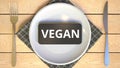 VEGAN text on the screen of smartphone on the plate. Food related IT related 3D rendering Royalty Free Stock Photo