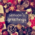 Text seasons greetings, gifts and christmas ornaments, retro eff