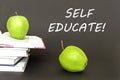 Text self educate, two green apples, open books with concept Royalty Free Stock Photo