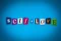 Text Self-Love on blue background from colorful letters. Multicolored inscription on card, banner. Headline, caption, heading. Psy